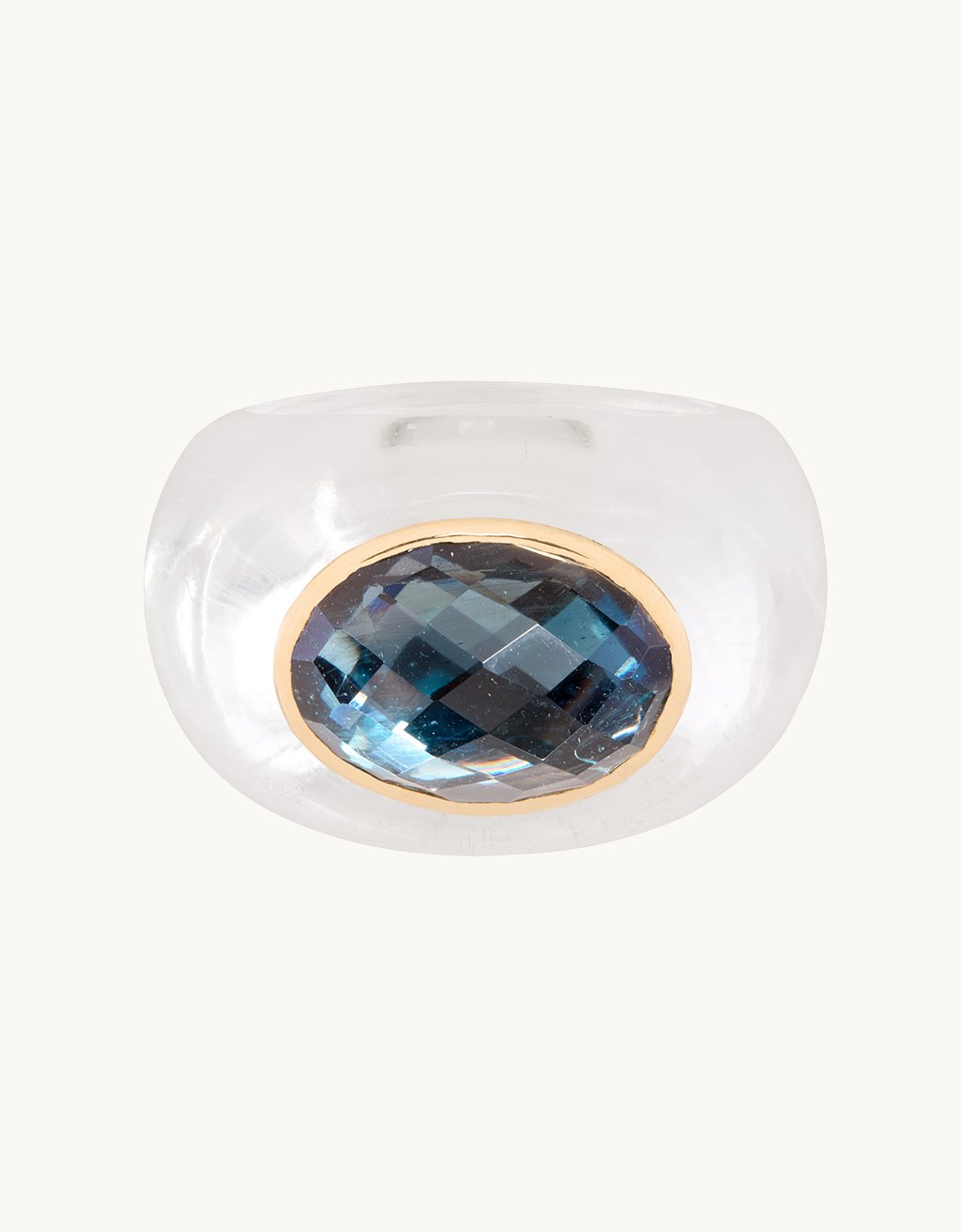 Crystal ring with a rose-cut blue topaz stone on a light gray background
