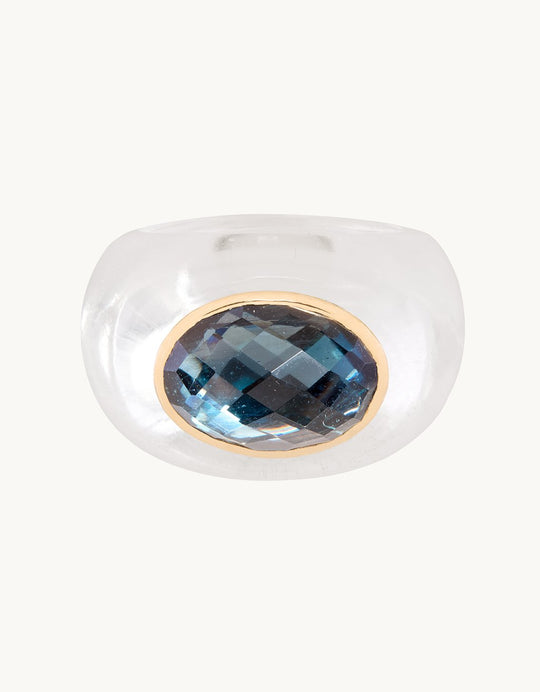 Crystal ring with a rose-cut blue topaz stone on a light gray background