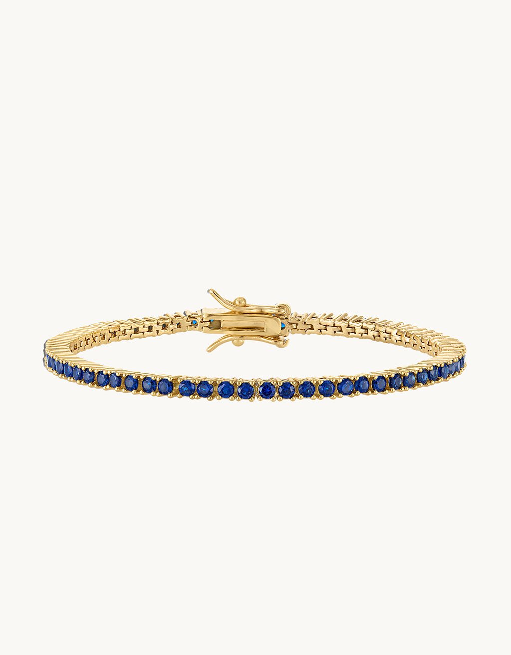 18k gold filled navy crystal tennis bracelet on a plain background