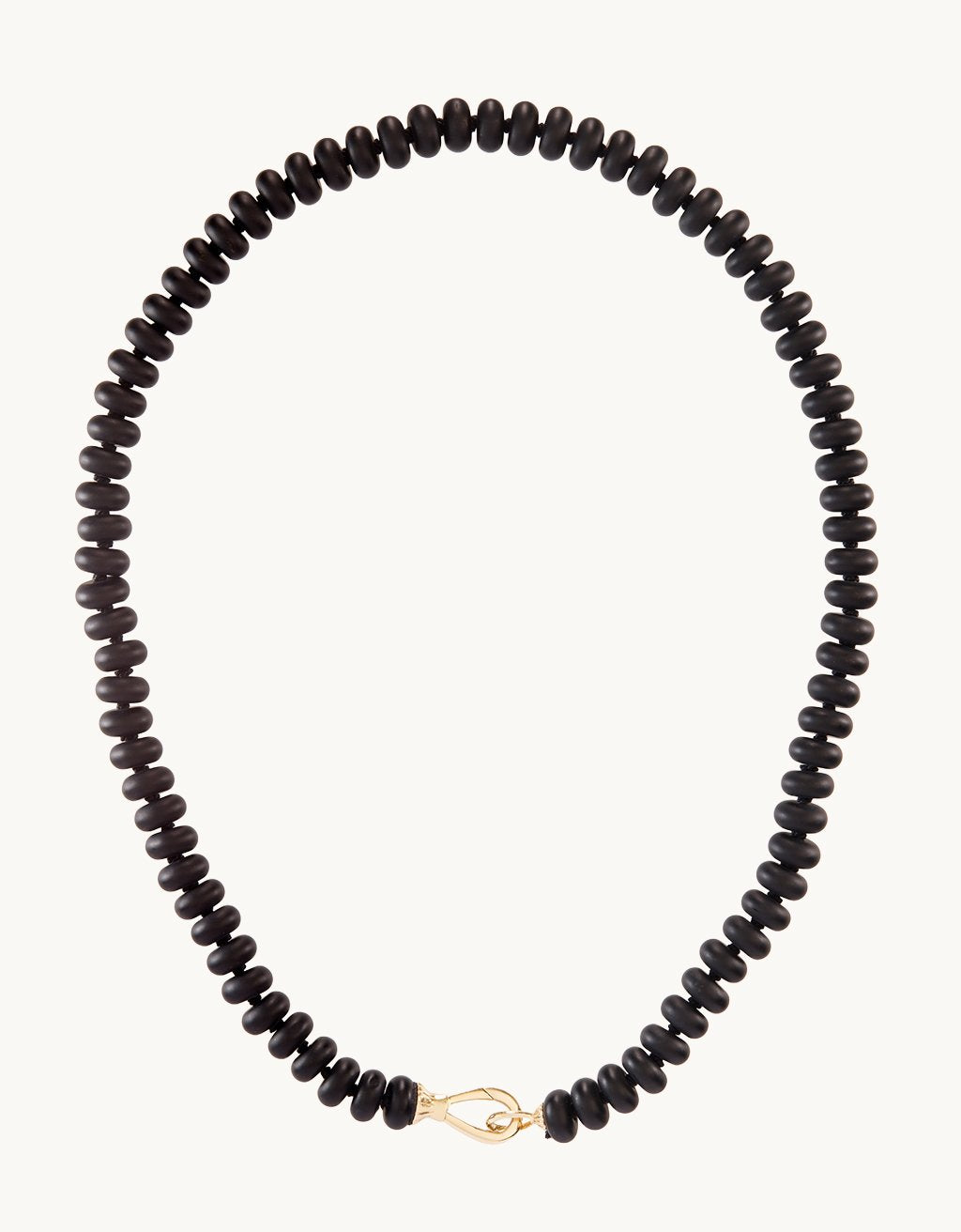 Black onyx rondelle beads strung on a knotted silk cord on a light gray background