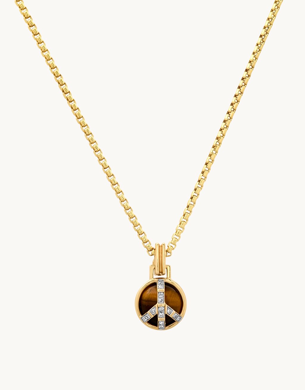 Gold peace sign pendant with a tiger's eye stone and diamond accents on a gold chain against a light gray background