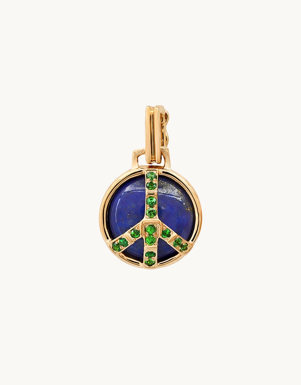 Peace sign gold pendant with blue stone and green gemstones on a light gray background