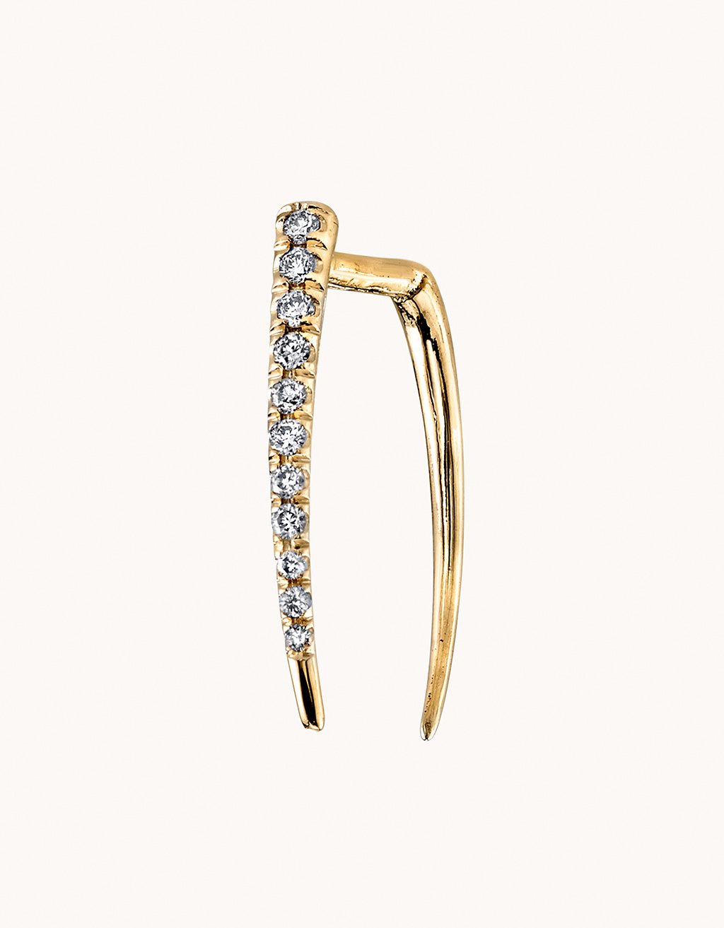 Gold earring with embedded diamonds on a light gray background