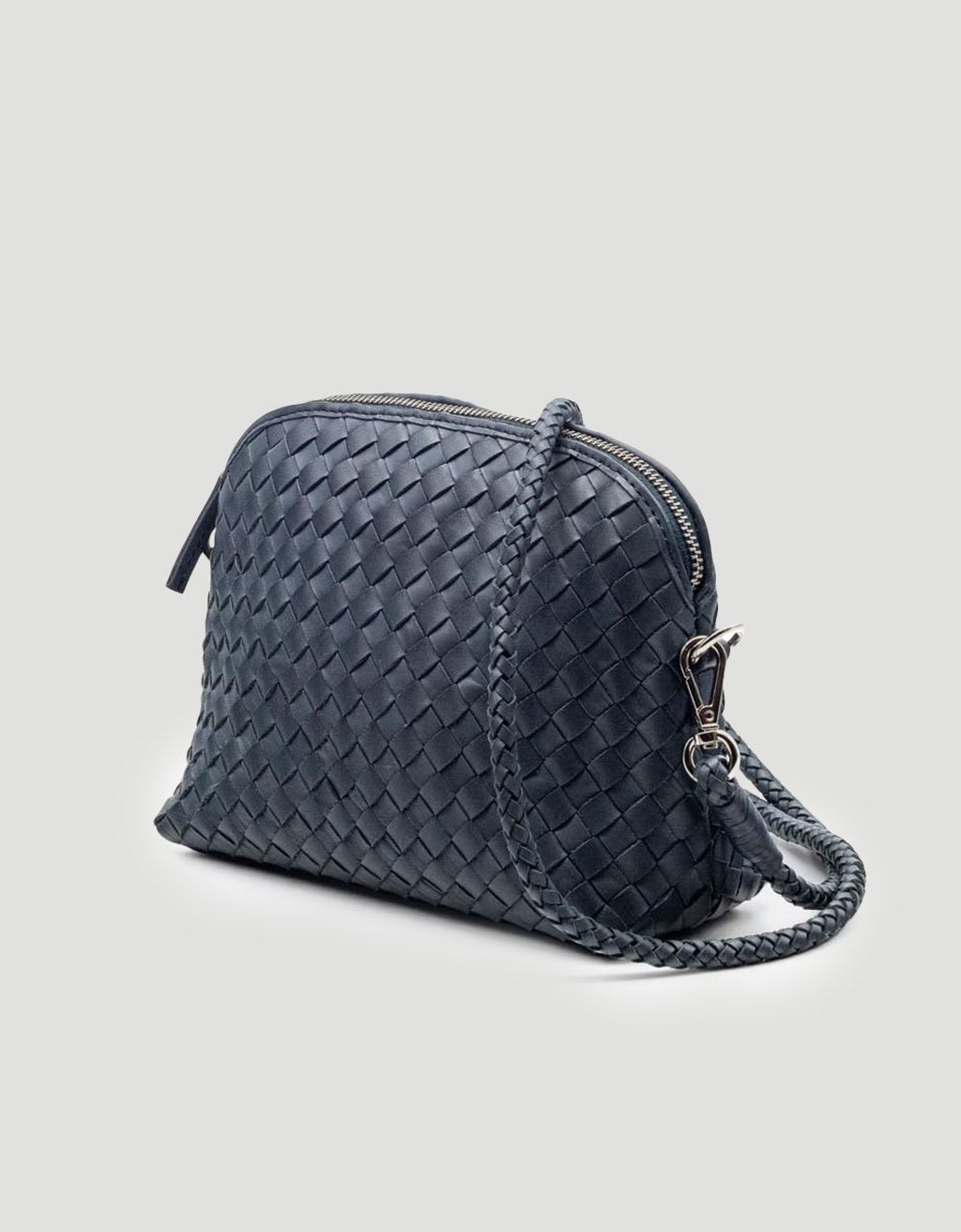 Navy woven handbag with detachable strap on a light gray background