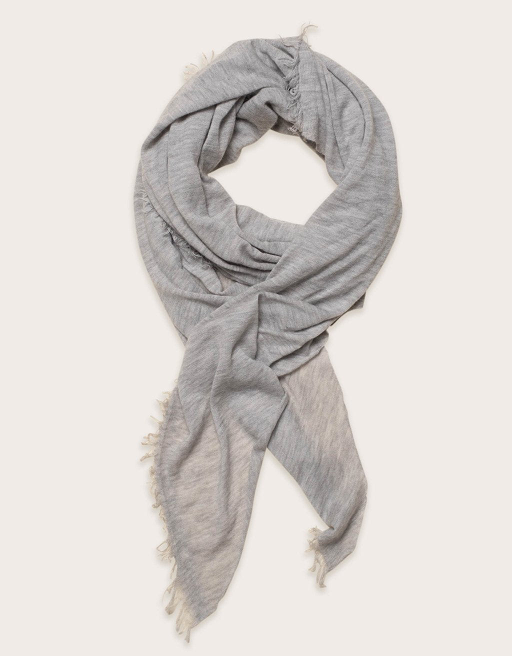 Gray cashmere scarf with fringe detail on a white background