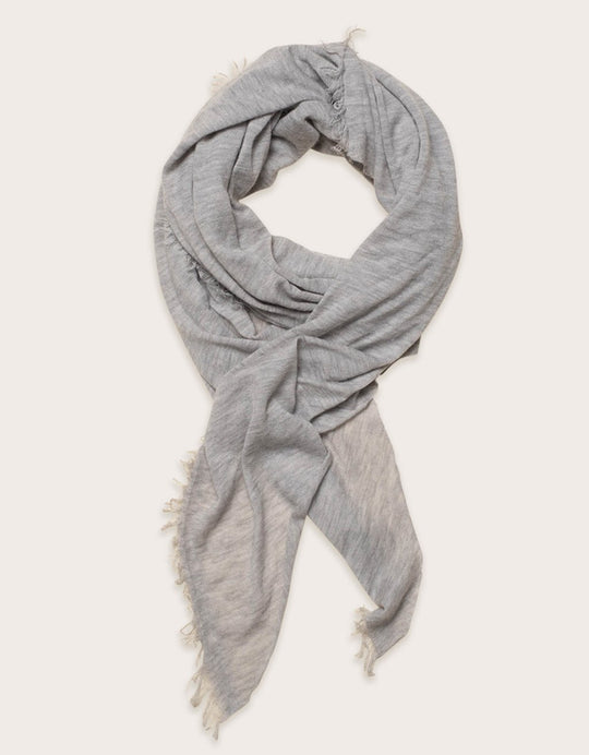 Gray cashmere scarf with fringe detail on a white background