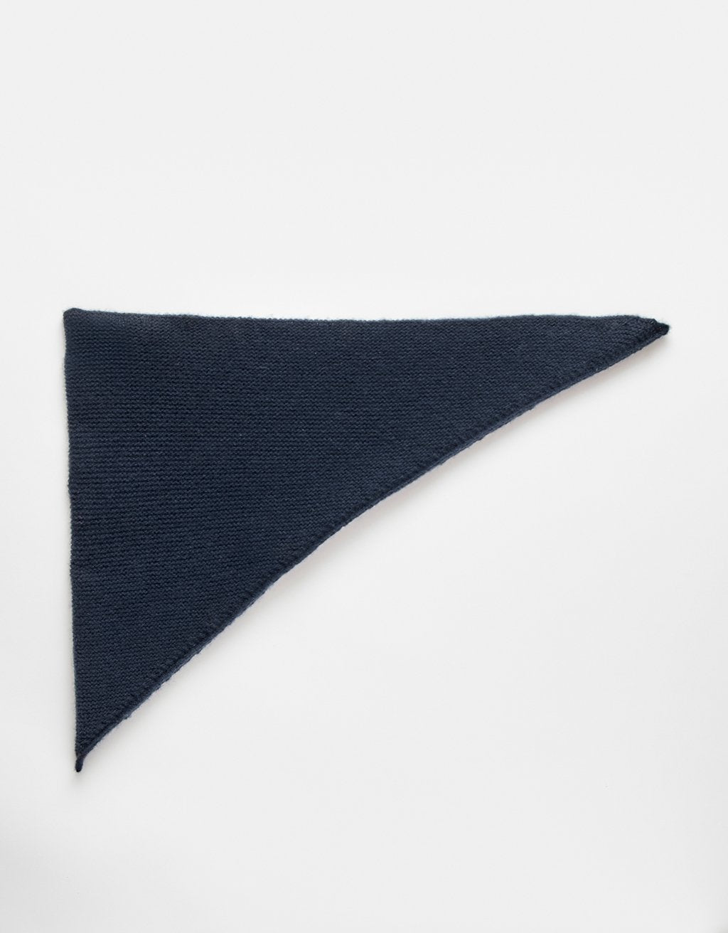 Navy blue cashmere scarf folded in a triangle on a white background